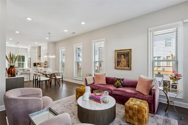 a living room with furniture kitchen and a window