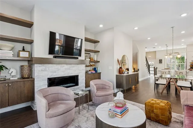 a living room with furniture fireplace and flat screen tv