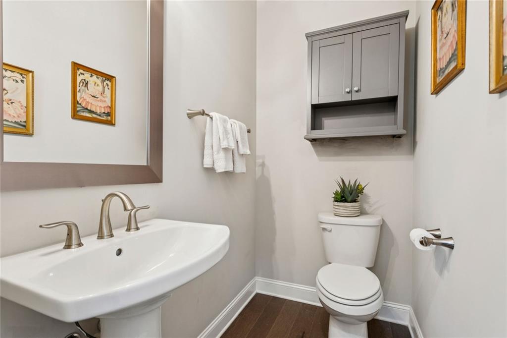 4219 Deming Circle Sandy Springs, GA 30342 - Photo 22 of 40 a bathroom with a toilet a sink and a mirror