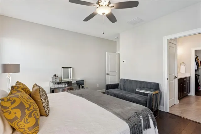 a bedroom with a bed and ceiling fan