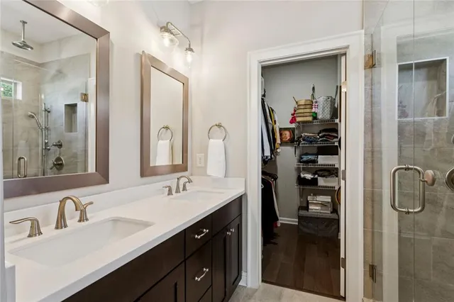 a en suite bathroom with a double vanity sink a and mirror