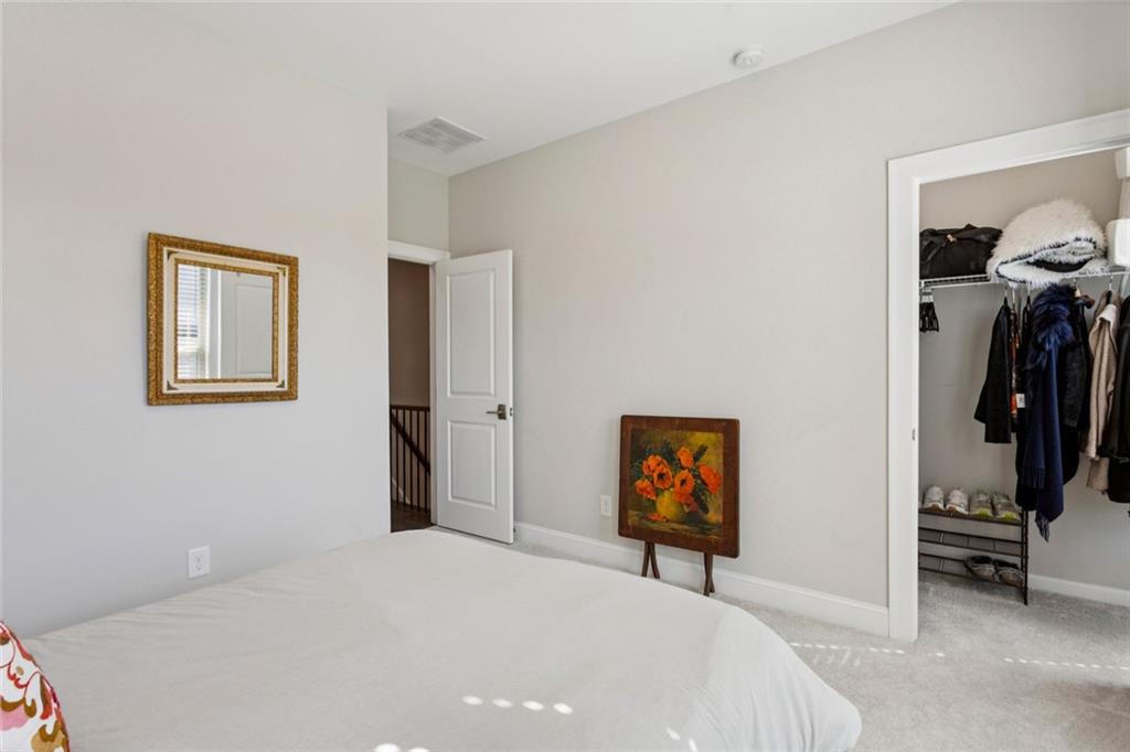 4219 Deming Circle Sandy Springs, GA 30342 - Photo 31 of 40 a bedroom with a bed and a view of bathroom