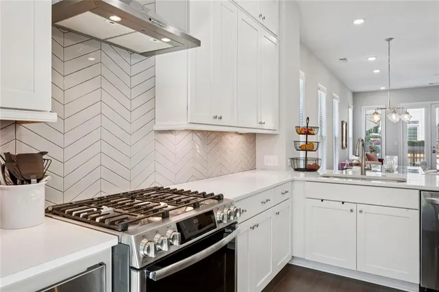 a white stove top oven sitting inside of a kitchen