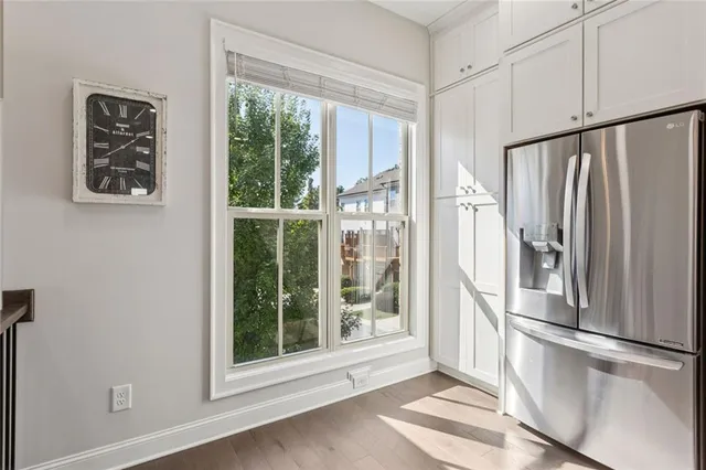 a view of a kitchen with wooden floor and a window