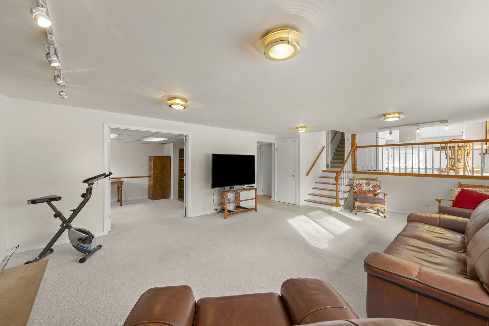 1308 Stonegate Road Naperville, IL 60540 - Photo 10 of 30 a living room with furniture and a flat screen tv