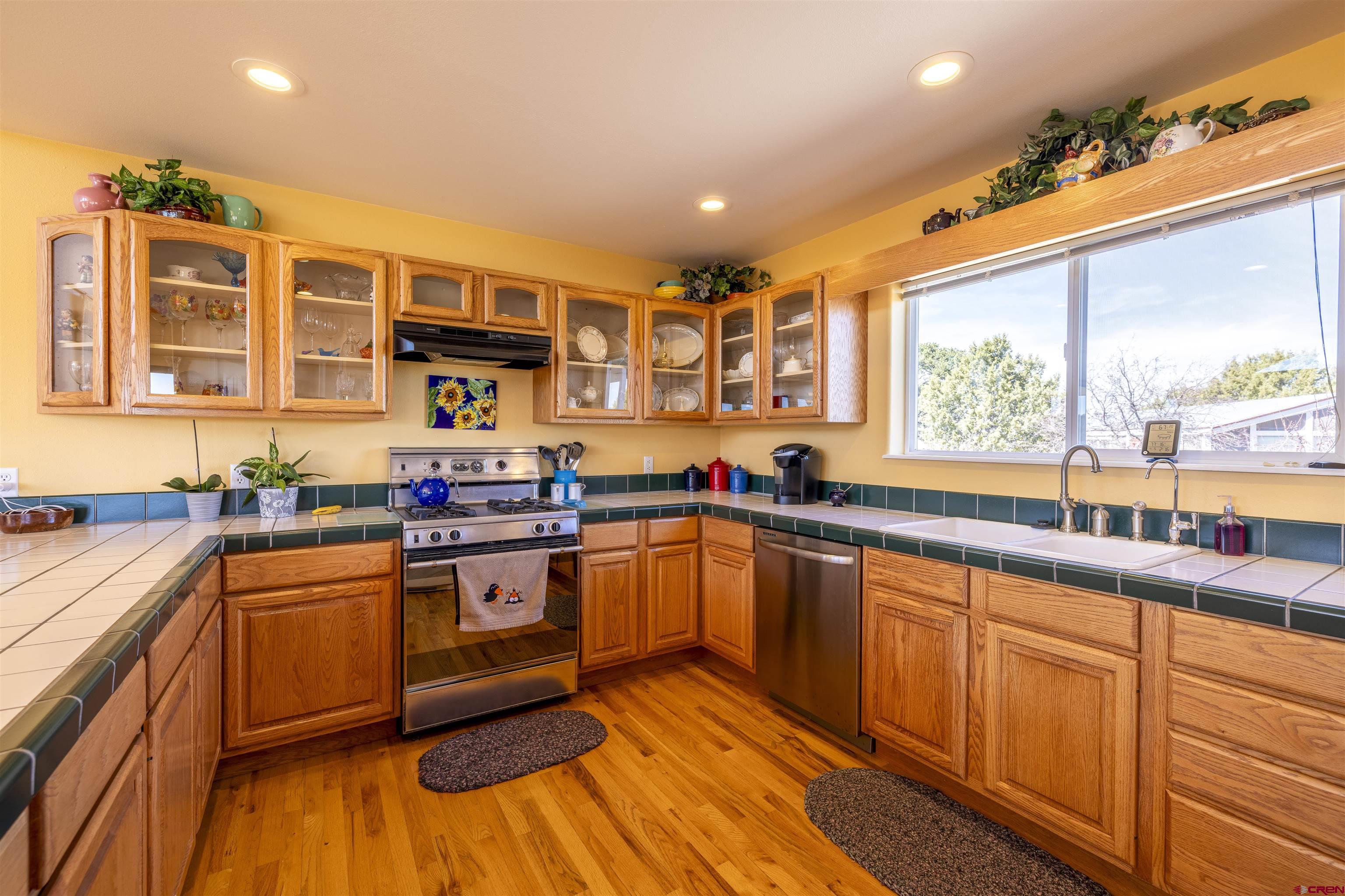 63 Sagewood Drive Ignacio, CO 81137 - Photo 13 of 33 a kitchen with stainless steel appliances granite countertop wooden cabinets a sink and a stove