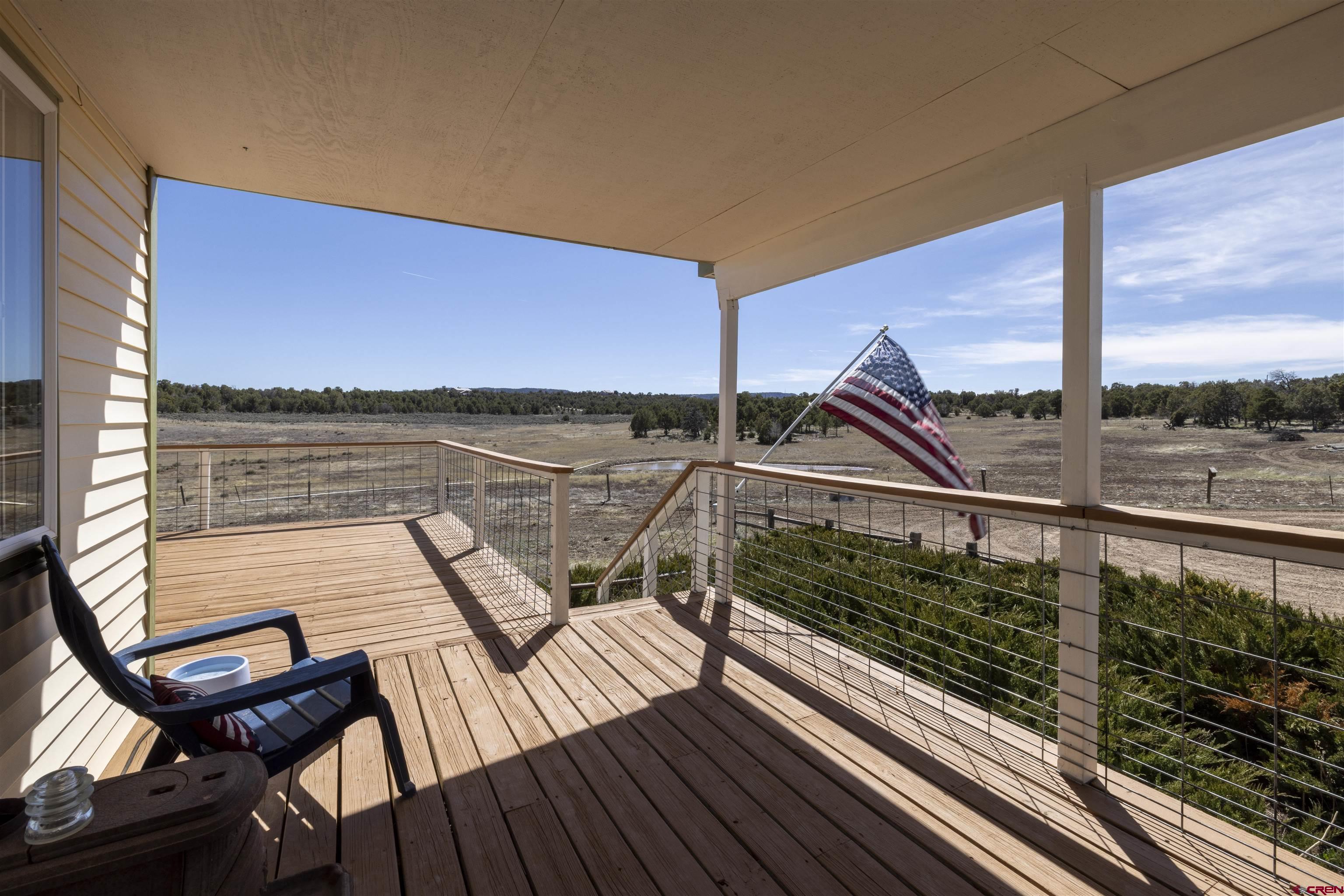 63 Sagewood Drive Ignacio, CO 81137 - Photo 6 of 33 a view of a balcony with wooden floor next to a yard
