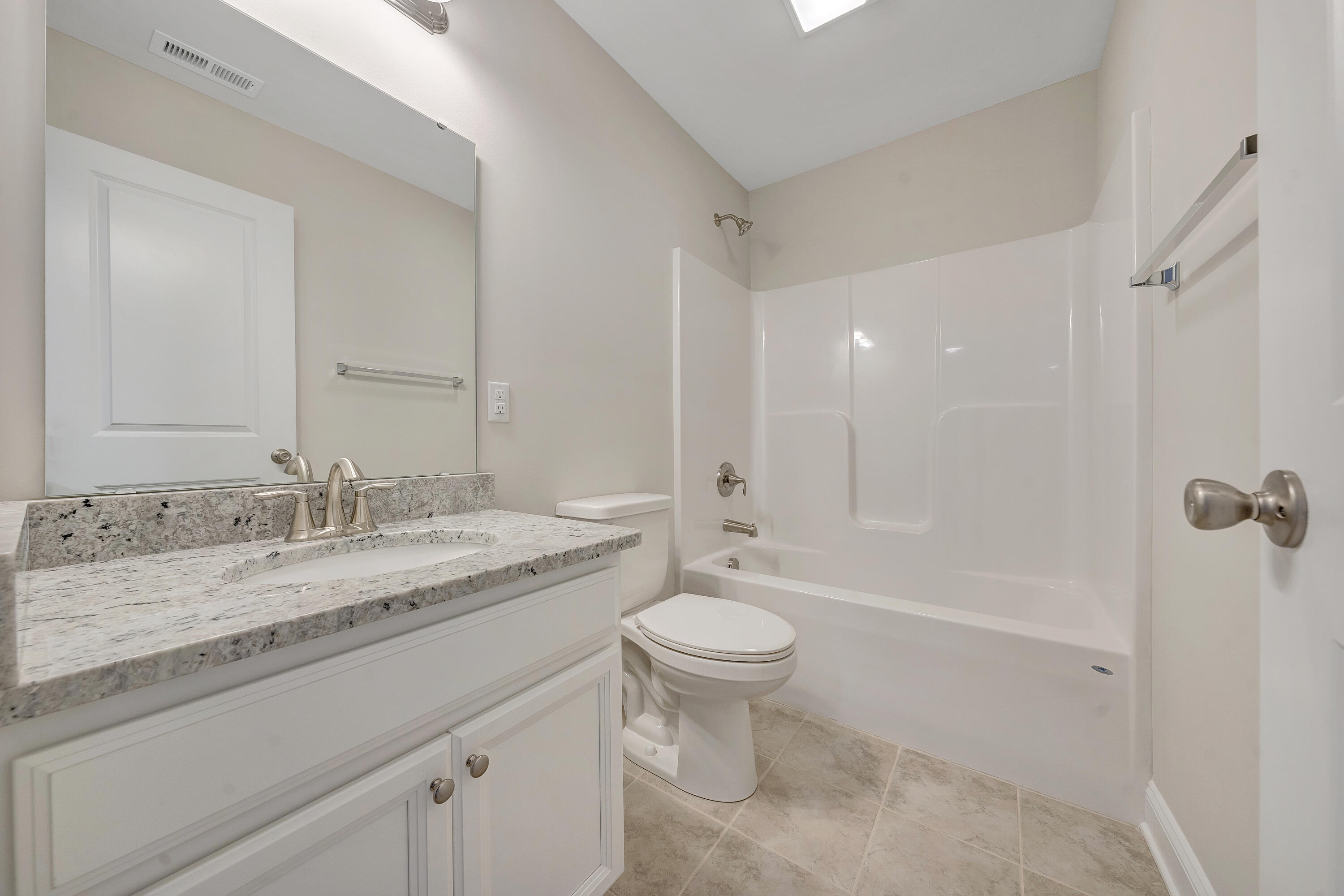5275 Arrowhead Trail Salem, VA 24153 - Photo 11 of 18 a bathroom with a granite countertop sink toilet mirror and bathtub