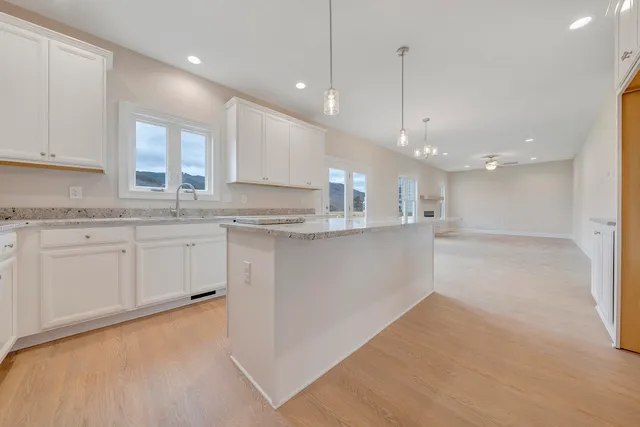 a kitchen with kitchen island a sink stainless steel appliances and cabinets