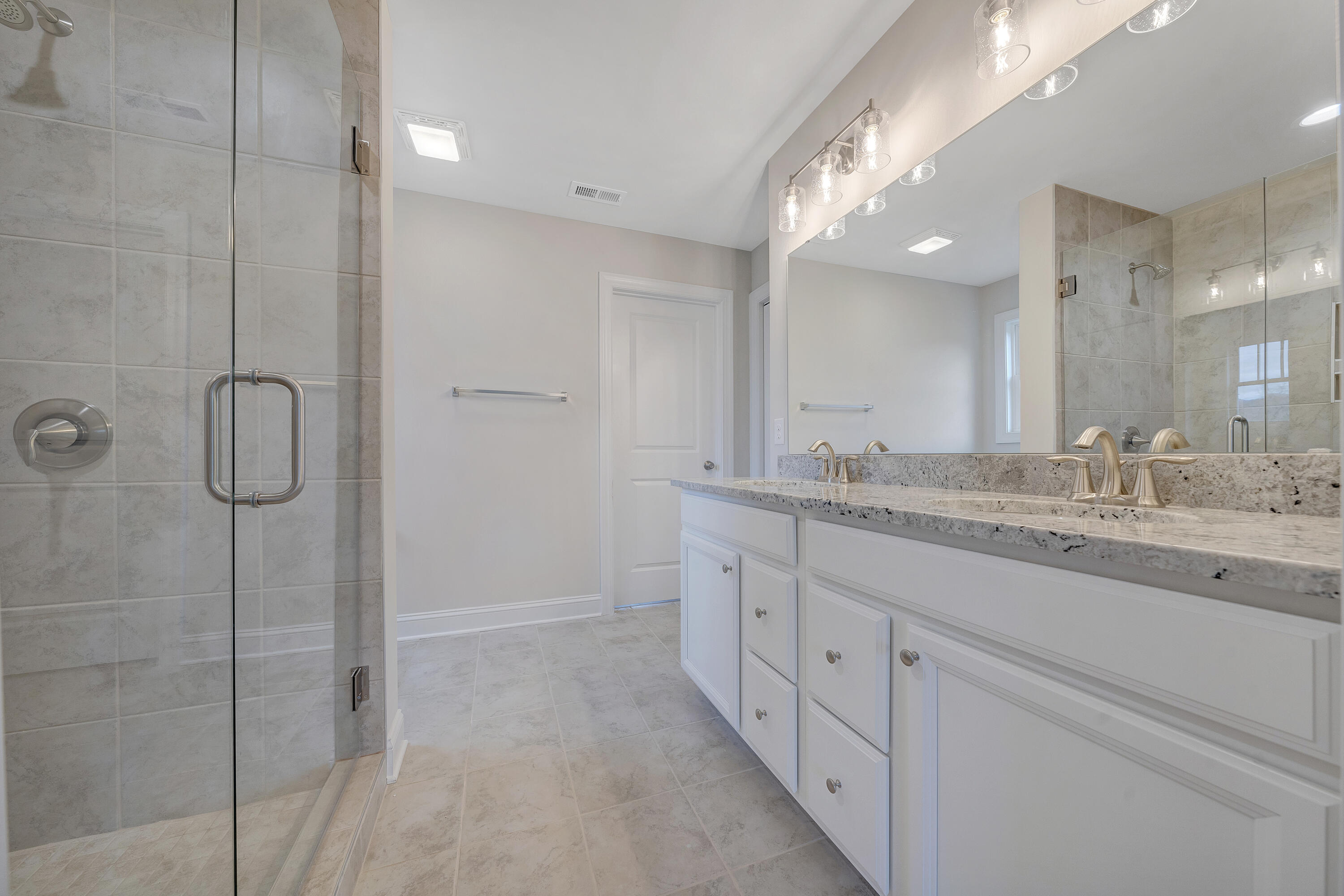 5275 Arrowhead Trail Salem, VA 24153 - Photo 10 of 18 a bathroom with a granite countertop sink two mirror and a shower