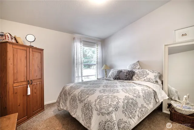 a bedroom with a bed and window