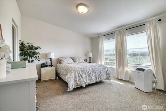 a spacious bedroom with a bed and a couch