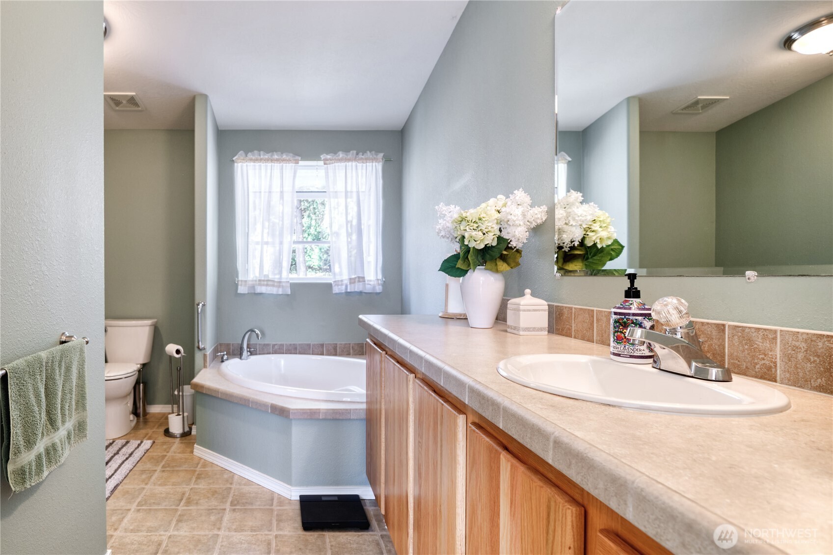 1940 APA Road Point Roberts, WA 98281 - Photo 17 of 35 a bathroom with a double vanity sink toilet and a mirror