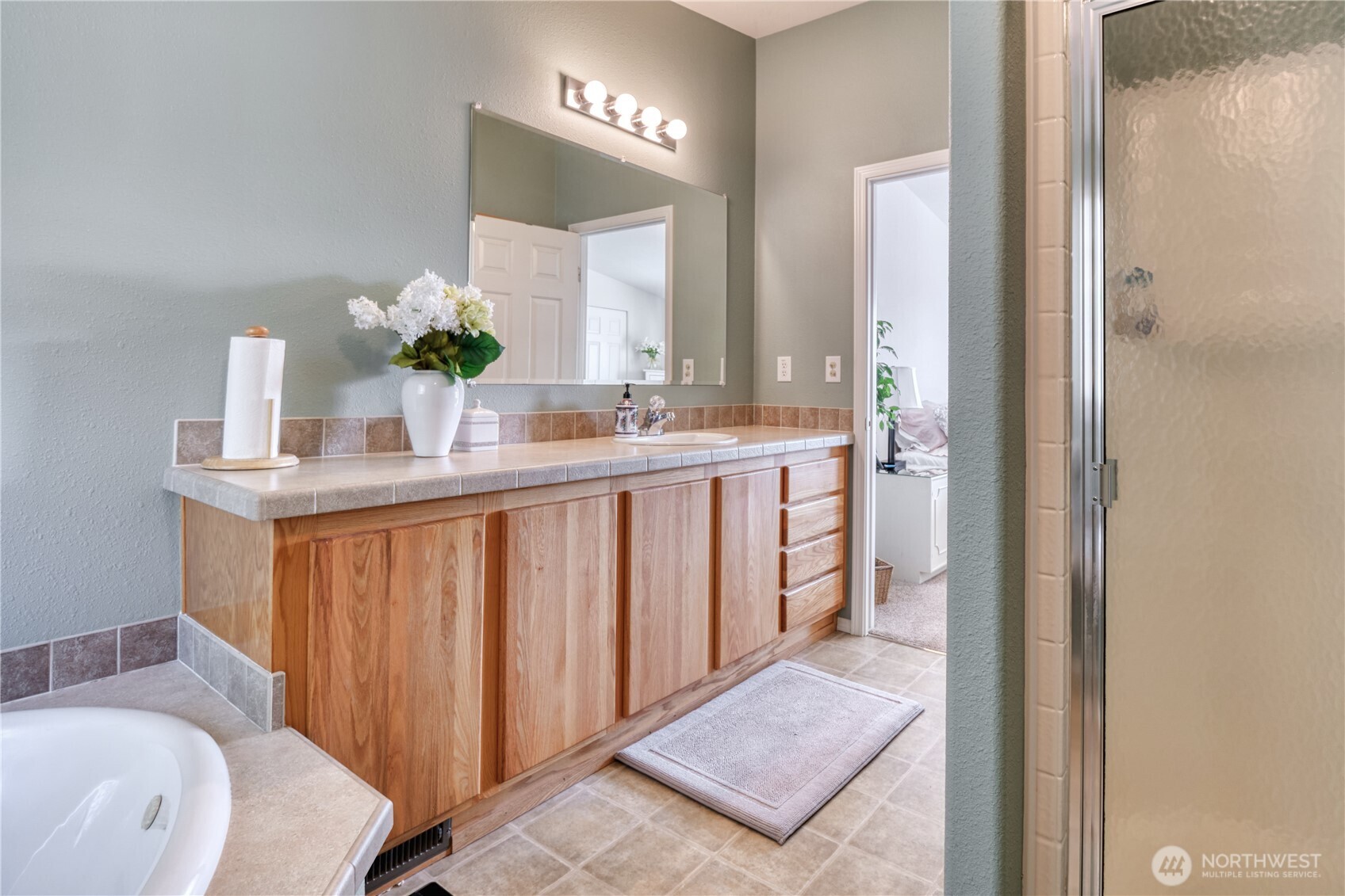 1940 APA Road Point Roberts, WA 98281 - Photo 18 of 35 a en suite bathroom with a granite countertop sink and a mirror