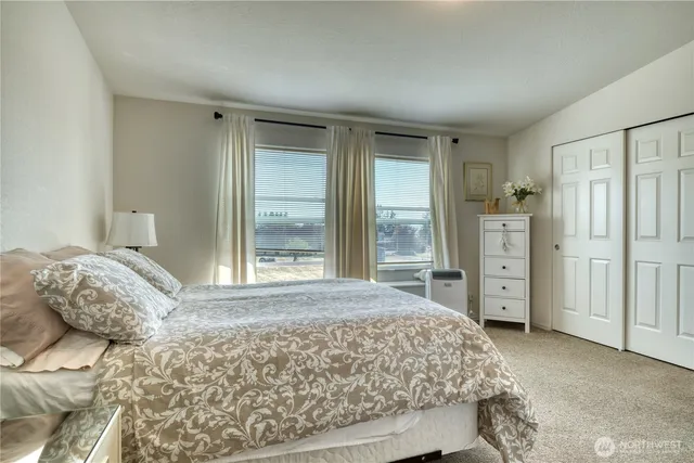 a bedroom with a large bed and a window