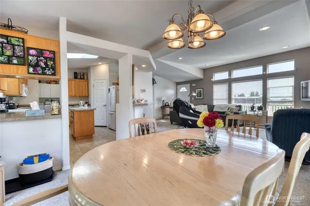 a living room with furniture a chandelier and a large window