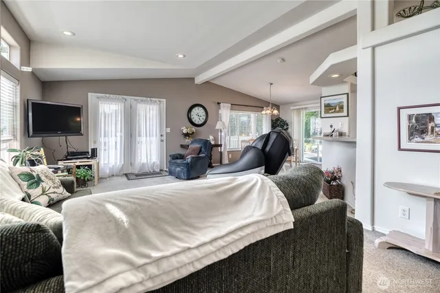 a bedroom with a bed a mirror and a large window