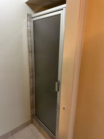 a bathroom with a glass shower door