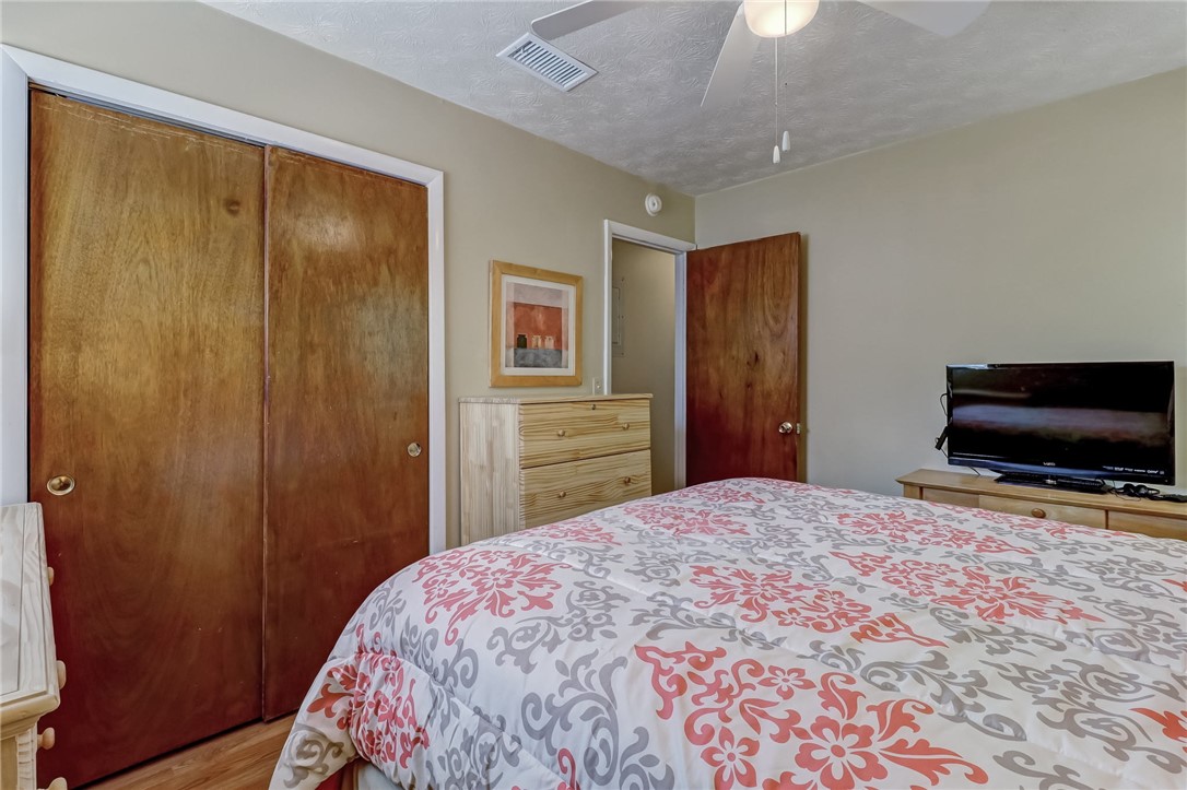 1401 Leon Street Fernandina Beach, FL 32034 - Photo 18 of 32 a bedroom with a bed and a flat screen tv