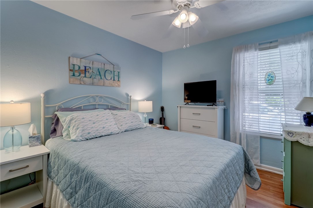 1401 Leon Street Fernandina Beach, FL 32034 - Photo 20 of 32 a bedroom with a large bed and a flat tv screen on dresser