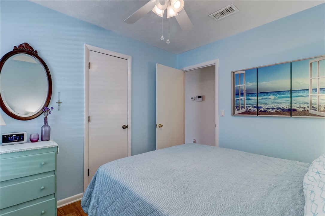 1401 Leon Street Fernandina Beach, FL 32034 - Photo 21 of 32 a bedroom with a bed and a chandelier