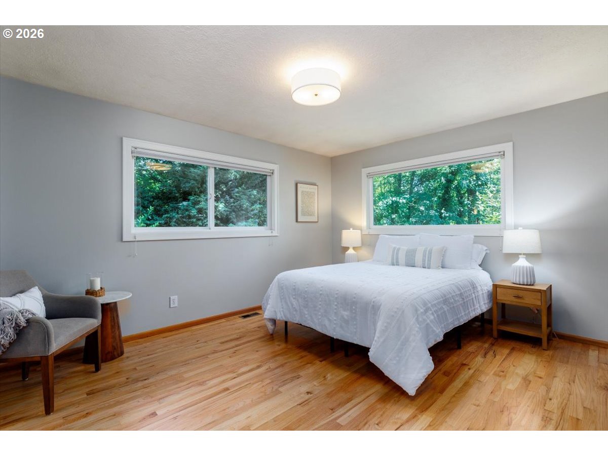 175 Northwest 95th Avenue Portland, OR 97229 - Photo 16 of 46 a bedroom with a bed and wooden floor