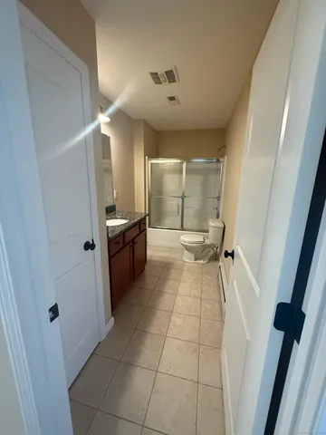 a view of a hallway to rooms and stairs