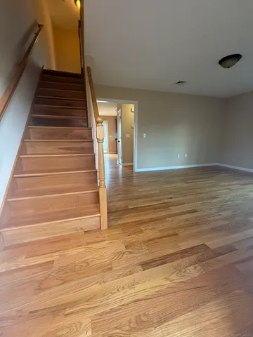 a view of entryway and hall with wooden floor