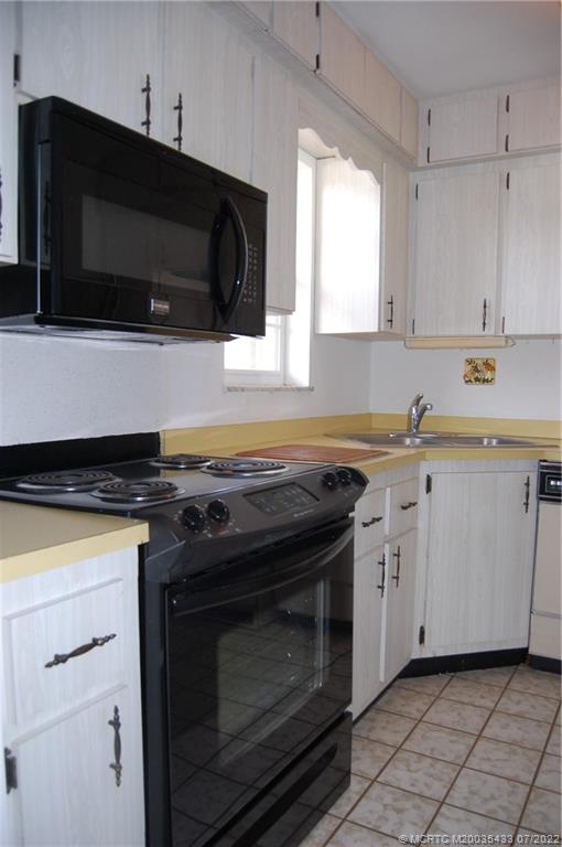 1927 Southwest Palm City Road, Unit E Stuart, FL 34994 - Photo 9 of 30 Range, microwave, dishwasher & refrigerator.
