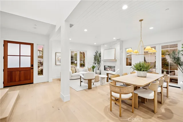a large white kitchen with a white countertops a stove a sink dishwasher and a oven with white cabinets