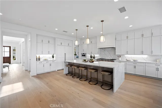 a kitchen with stainless steel appliances granite countertop a sink a stove and a cabinets