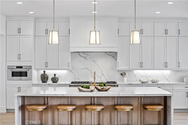 a kitchen with a table chairs stove and white cabinets