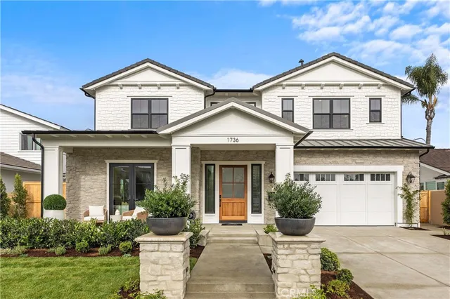 a front view of a house with yard and green space