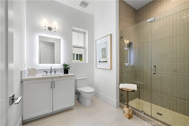 a bathroom with a sink toilet a mirror and tub