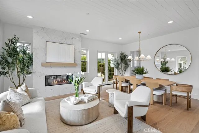 a living room with furniture a mirror and a large mirror