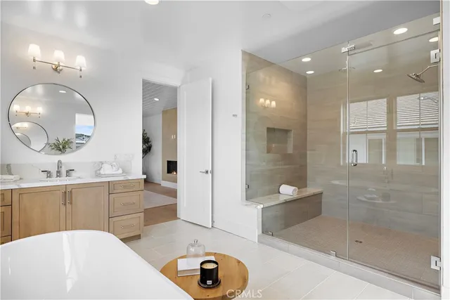 a living room with fireplace furniture and a large window