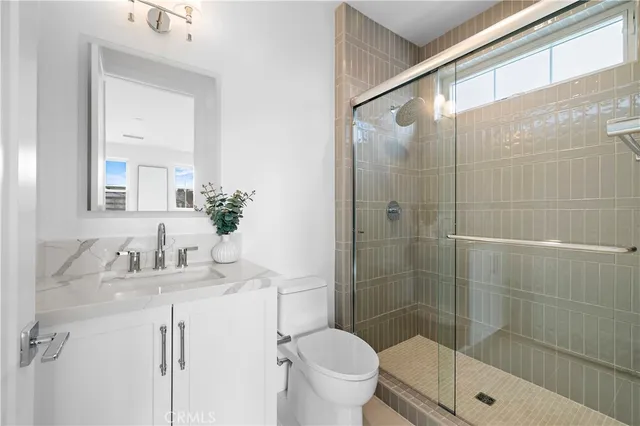 a front view of a house with a yard and potted plants