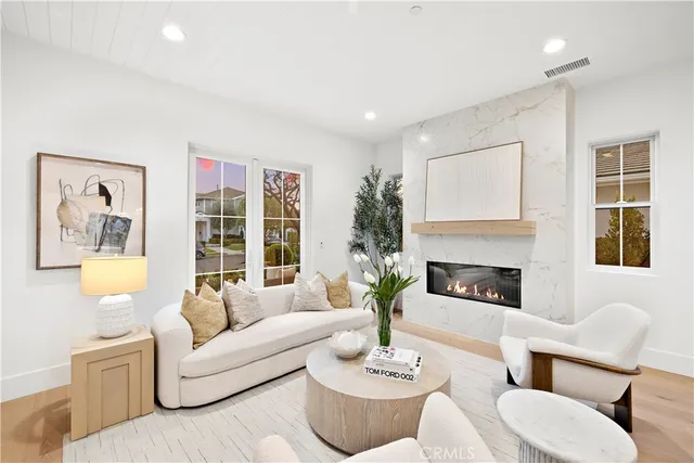 a living room with furniture large window and fireplace