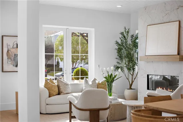 a living room with fireplace furniture and a chandelier