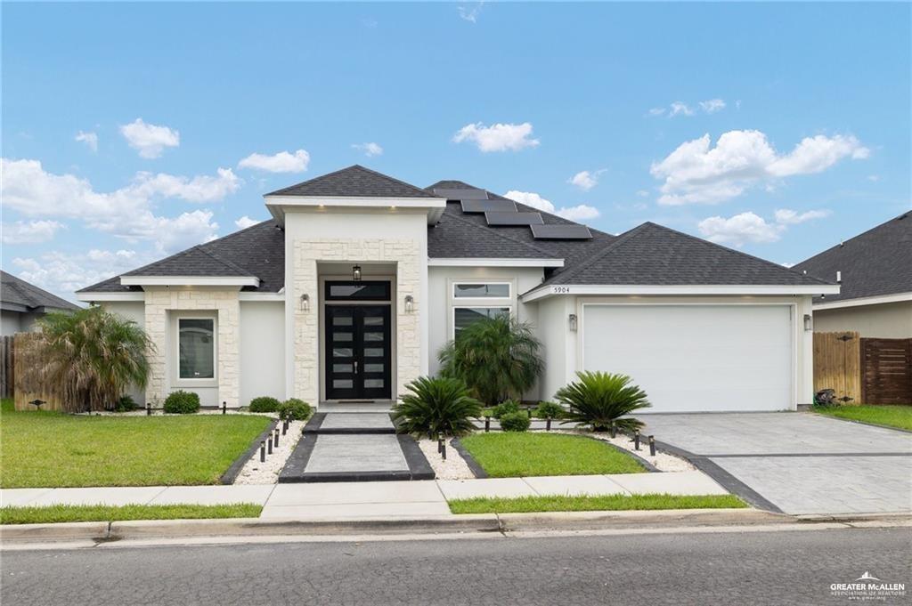 5904 North Dodger Street Pharr, TX 78577 - Photo 1 of 24 a front view of a house with a yard and potted plants