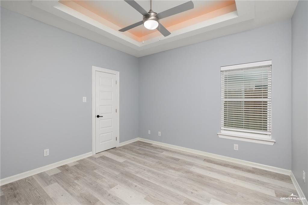 5904 North Dodger Street Pharr, TX 78577 - Photo 11 of 24 a view of empty room with wooden floor and fan