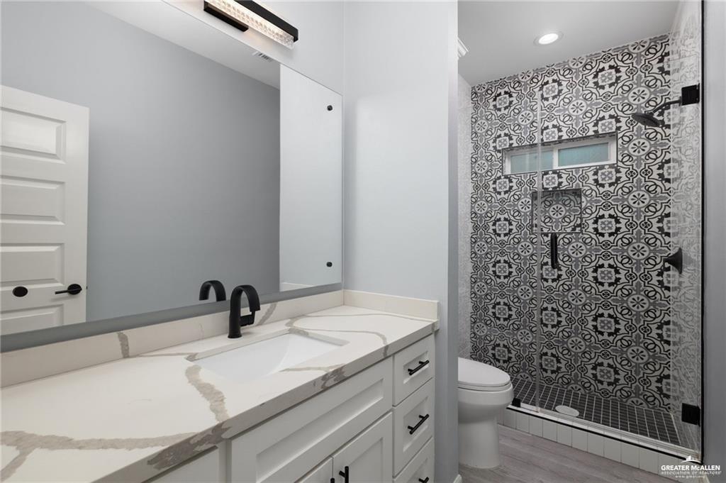 5904 North Dodger Street Pharr, TX 78577 - Photo 12 of 24 a bathroom with a sink toilet and shower