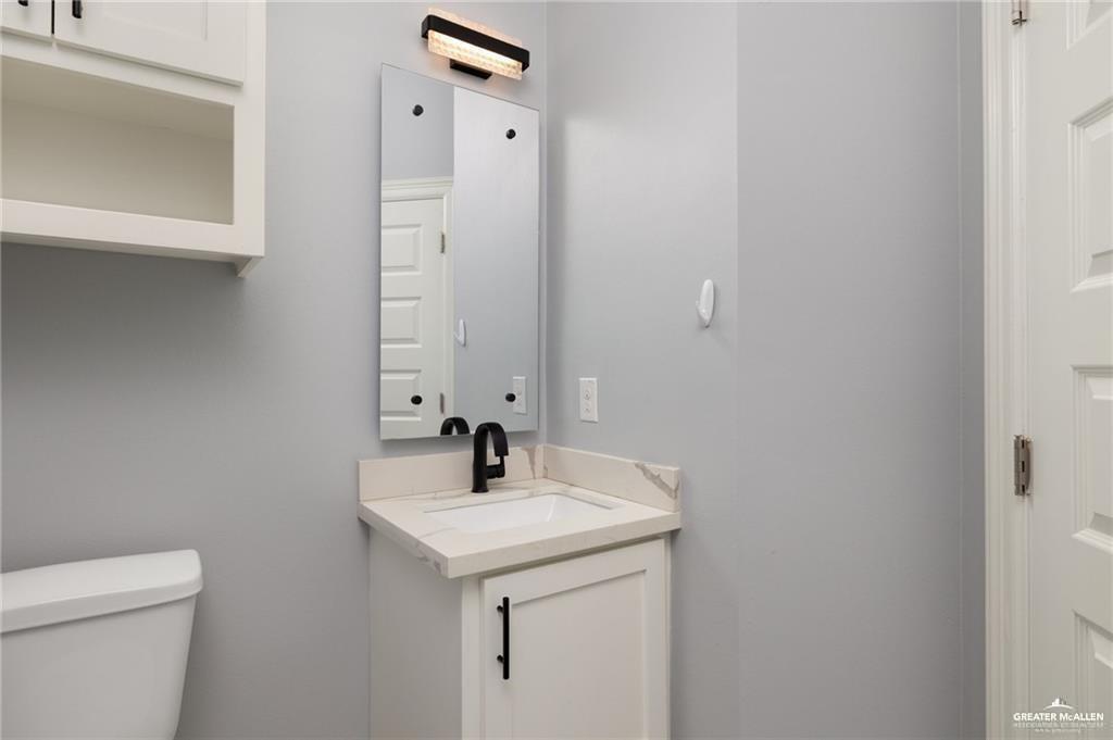 5904 North Dodger Street Pharr, TX 78577 - Photo 16 of 24 a bathroom with a sink and a toilet