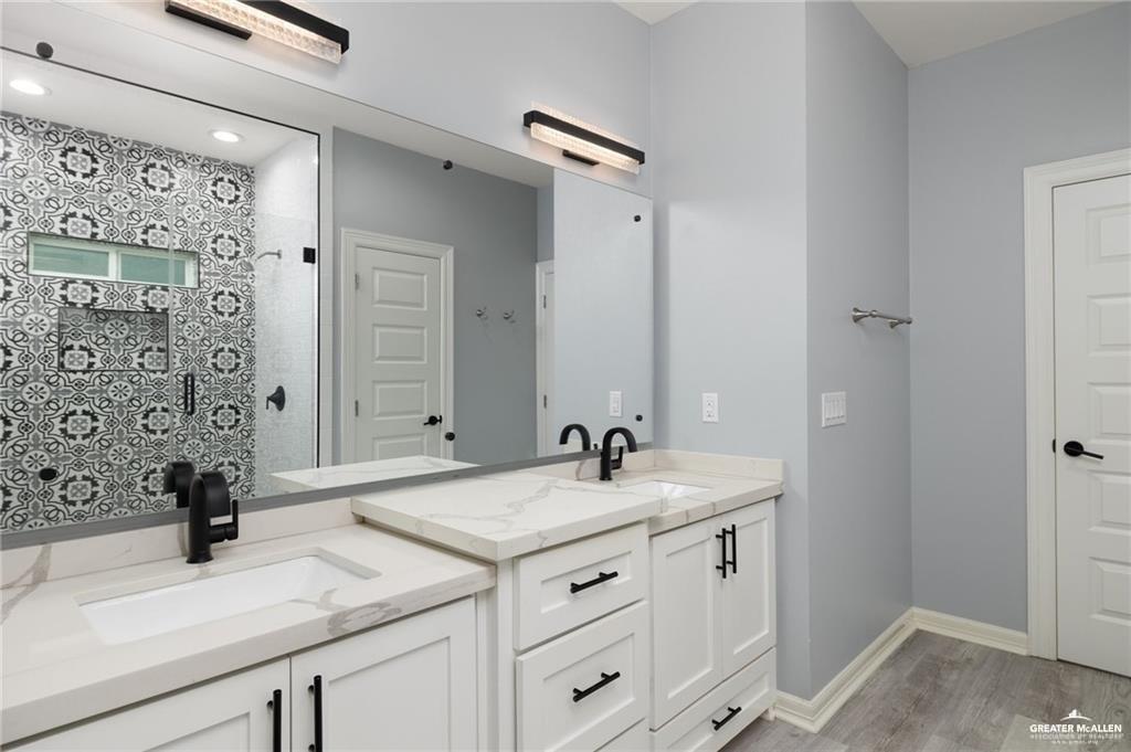 5904 North Dodger Street Pharr, TX 78577 - Photo 9 of 24 a bathroom with a sink and a mirror