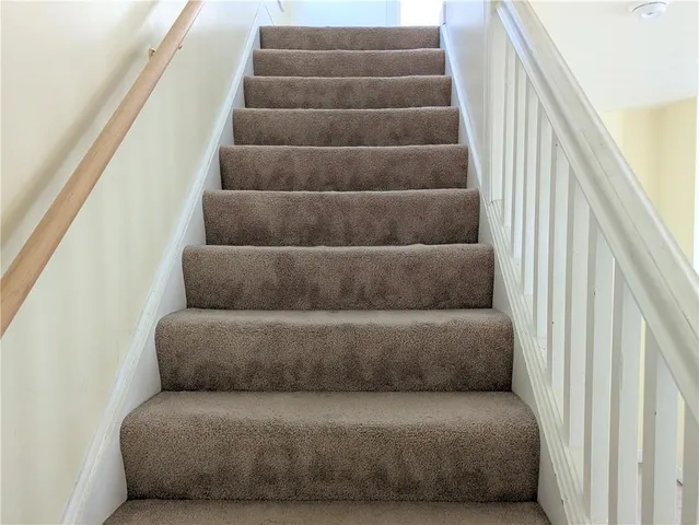 a view of staircase with white walls