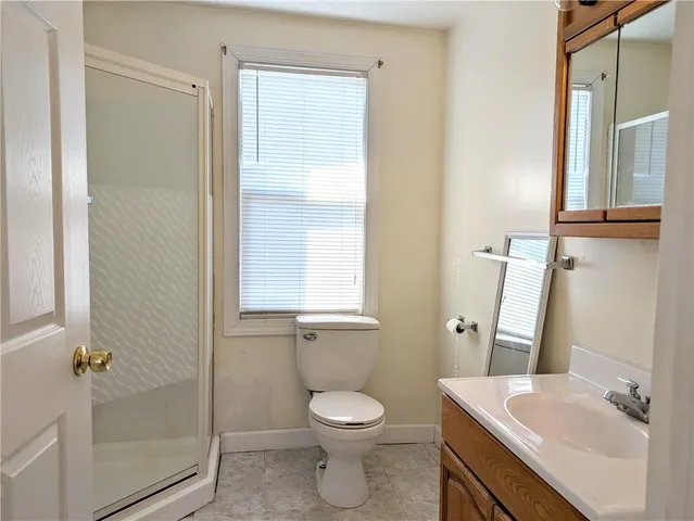 a bathroom with a toilet a sink and shower
