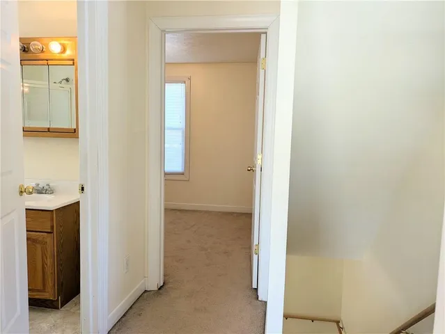 a view of a bathroom from a corridor