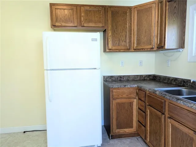 a kitchen with a sink and a refrigerator
