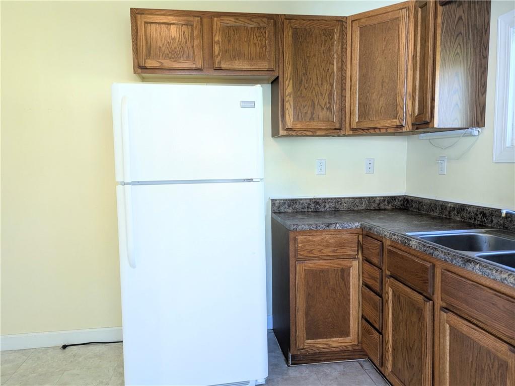 716 George Street Scottdale, PA 15683 - Photo 8 of 30 a kitchen with a sink and a refrigerator