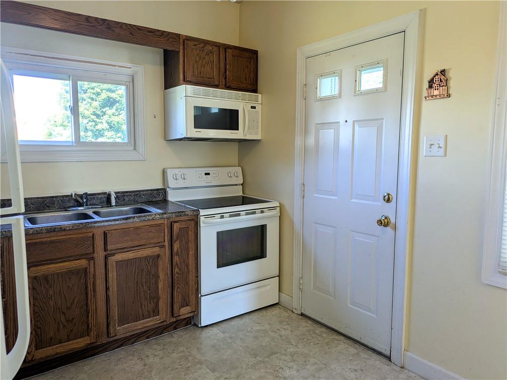 716 George Street Scottdale, PA 15683 - Photo 9 of 30 a kitchen with stainless steel appliances a stove and a microwave